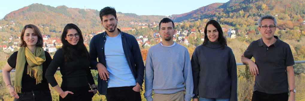 Group picture with Jena in fall colors in the background.